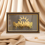 Load image into Gallery viewer, Decorative wall art with a gold sun and horse design on a black background, framed in gold, against a beige curtain.