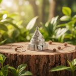 Load image into Gallery viewer, Silver pyramid-shaped object on a wooden stump with a natural background