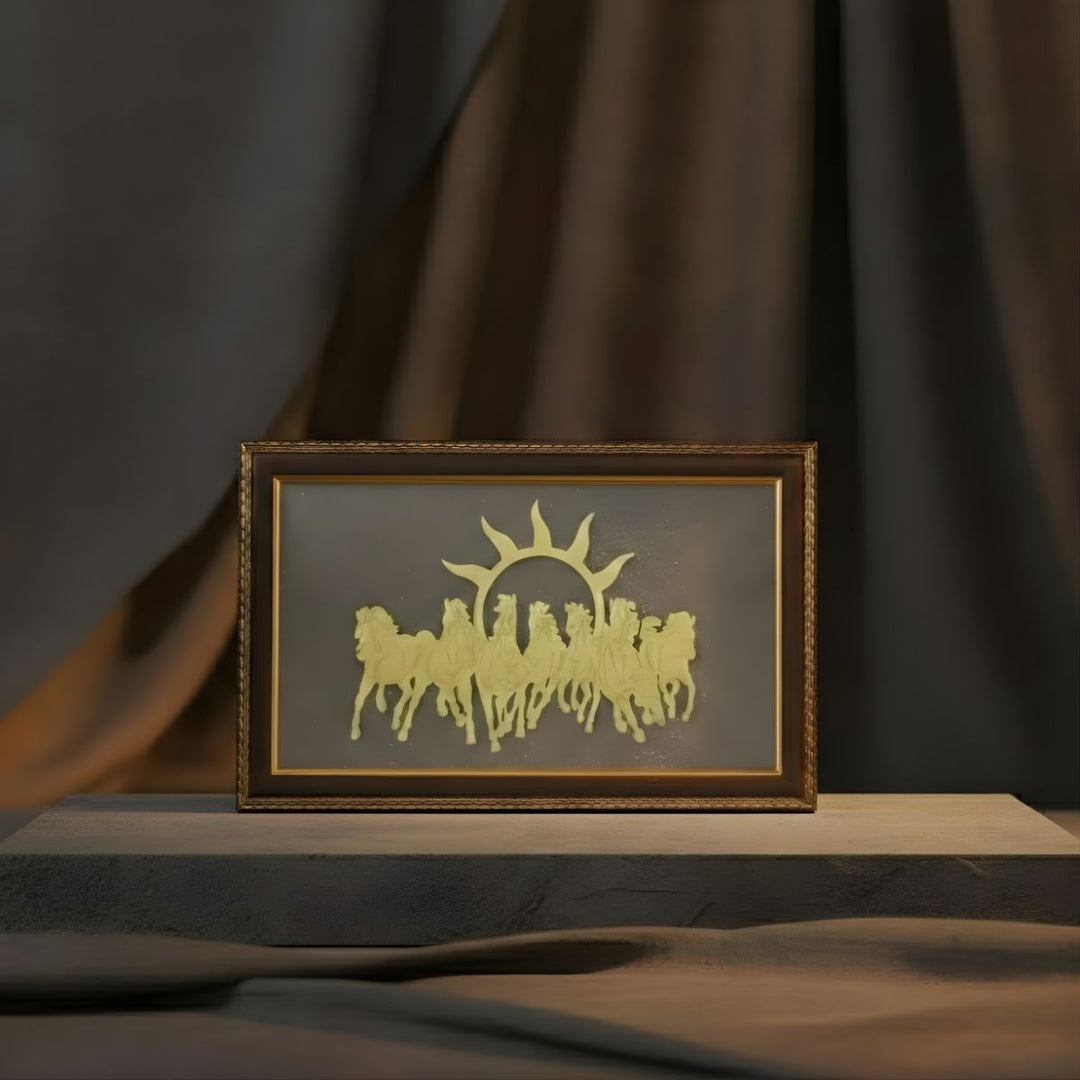 Framed artwork of a sun and horses on a dark background