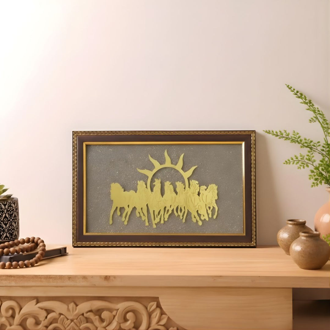 Decorative wall art with horses and a sun on a wooden shelf.
