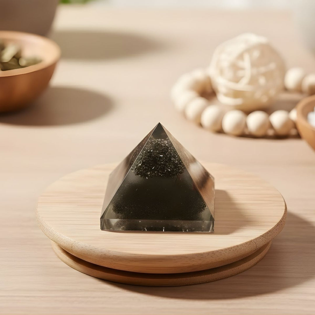 Pyramid-shaped crystal on a wooden stand with a blurred background