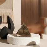 Load image into Gallery viewer, Pyramid-shaped object on a white base with a blurred background